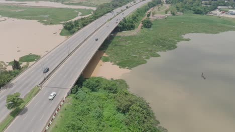 AERIAL---Highway-next-to-Jabi-Lake-reservoir-in-Abuja,-Nigeria,-Africa,-forward
