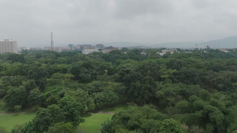 AERIAL---forested-area-under-a-cloudy-sky,-Abuja,-Nigeria,-reverse