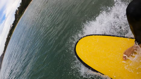 POV-first-person-view-of-surfer-surfing-on-foam-board