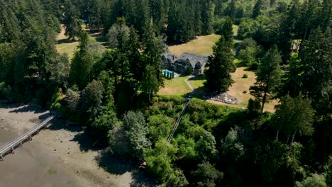 Aerial-view-of-a-mansion-with-a-private-dock-in-Freeland,-Washington