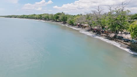 Aerial-flyover-tropical-PLAYA-PALENQUE-with-palm-trees-and-small-beach-in-summer