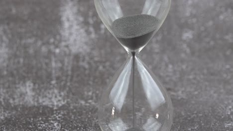 Hour-glass-with-sands-flowing-through-the-stem