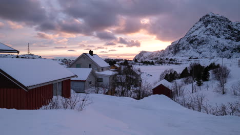 Sunset-behind-Small,-Snowy-Village-in-Northern-Norway