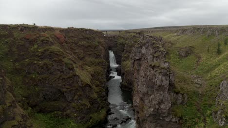 Flying-Over-Kolugljufur-Canyon-To-Scenic-Waterfall-In-North-Iceland