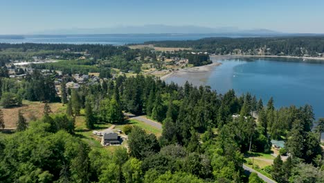 Establishing-aerial-view-of-Freeland,-Washington-with-the-Olympic-Mountains-off-in-the-distance