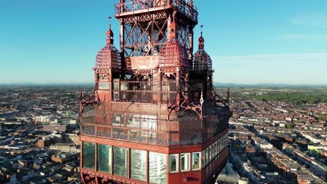 Aerial-drone-flight-around-Blackpool-Towers-observation-platform-showing-the-glass-floor-and-a-skyline-of-the-coastline