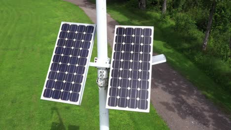Street-light-powered-by-solar-panels,-aerial-closeup-view