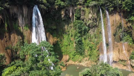 An-aerial-rotational-drone-shot-of-one-of-the-huge-waterfalls-of-Thi-Lo-Su-Waterfall,-located-off-the-beaten-track-in-the-backpacker's-paradise-of-North-Thailand-in-the-area-of-Umphang