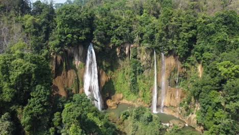 An-aerial-rotational-drone-shot-of-Thi-Lo-Su-Waterfall,-located-off-the-beaten-track-in-backpackers-paradise-of-North-Thailand-in-the-area-of-Umphang-in-Southeast-Asia
