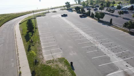Drone-swooping-down-near-seagulls-in-a-parking-lot