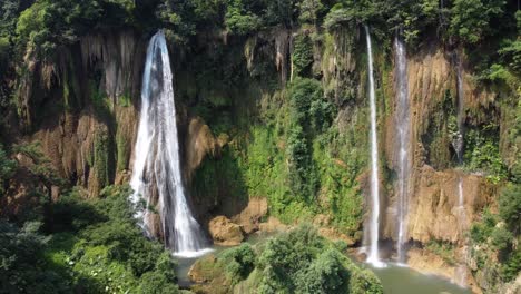 An-aerial-rotational-4K-drone-shot-of-one-of-the-huge-waterfalls-of-Thi-Lo-Su-Waterfall,-located-deep-in-the-jungle-in-the-country-of-Thailand-in-the-area-of-Umphang-in-Southeast-Asia