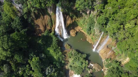 An-amazing-drone-shot-flying-away-from-Thi-Lo-Su-Waterfall-and-seen-from-above,-located-off-the-beaten-track-deep-in-the-jungle-of-North-Thailand-in-the-area-of-Umphang-in-Southeast-Asia