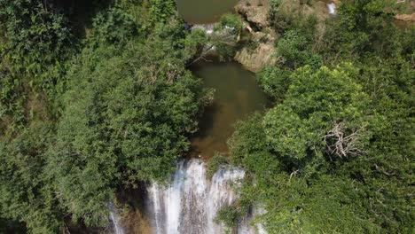 Drone-shot-flying-above-one-of-the-smaller-waterfalls-of-Thi-Lo-Su-Waterfall,-located-deep-in-the-jungle,-off-the-beaten-track-of-North-Thailand-in-the-area-of-Umphang-in-Southeast-Asia