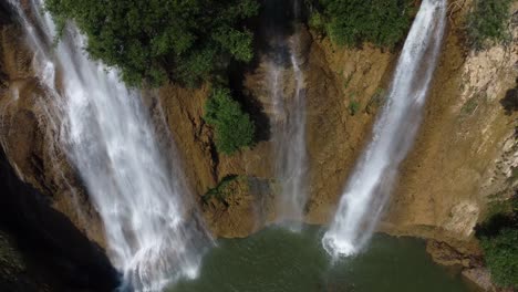 A-stunning-drone-shot-of-Thi-Lo-Su-Waterfall-seen-from-above,-located-deep-in-the-jungle,-off-the-beaten-track-in-the-backpacker's-paradise-country-of-Thailand-in-the-area-of-Umphang-in-Southeast-Asia