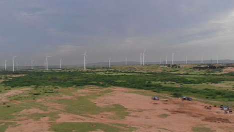 A-drone-shot-of-a-wind-power-plant-turbines-in-daylight-for-electricity-production-in-Jhimpir-Sindh,-Pakistan