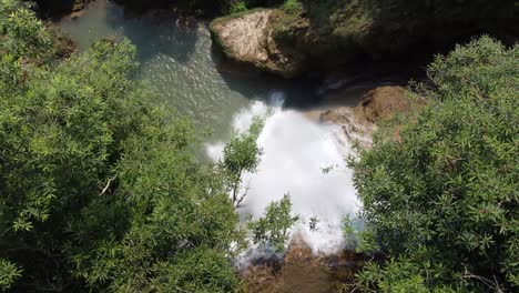Drone-shot-of-one-of-the-smaller-waterfalls-of-Thi-Lo-Su-Waterfall-seen-from-above,-located-deep-in-the-jungle,-off-the-beaten-track-of-North-Thailand-in-the-area-of-Umphang-in-Southeast-Asia