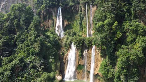 A-gorgeous-4K-drone-shot,-rotating-around-Thi-Lo-Su-Waterfall-in-the-adventures-jungle-of-Umphang,-located-in-the-country-of-Thailand-in-Southeast-Asia