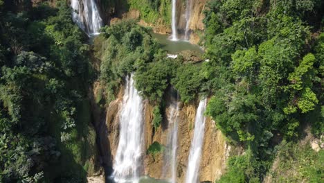An-adventurous-drone-shot,-flying-toward-Thi-Lo-Su-Waterfall,-located-off-the-beaten-track-in-the-backpacker's-paradise-country-of-Thailand-in-the-area-of-Umphang-in-Southeast-Asia