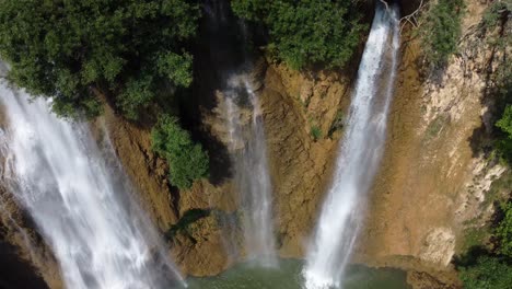 A-scenic-4K-drone-shot-of-three-of-the-small-waterfalls-of-Thi-Lo-Su-Waterfall-in-the-adventures-jungle-landscape-of-North-Thailand,-located-in-the-area-of-Umphang-in-Asia