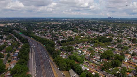 A-high-angle,-time-lapse-over-a-residential-neighborhood-on-Long-Island,-NY-by-a-parkway