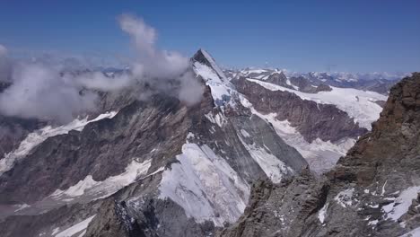 Stunning-aerial-view-of-The-Matterhorn,-Mount-Cervino,-Mont-Cervin-and-surrounding-mountains-and-valleys-of-the-Alps