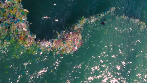Vertical-shot-of-plastic-bags-and-rubbish-floating-in-sea-waters