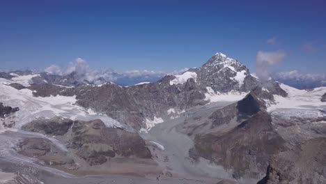 Wide-panoramic-view-of-snow-and-glaciers-in-Alps-with-Mount-Cervino,-Mont-Cervin-and-The-Matterhorn-in-the-background