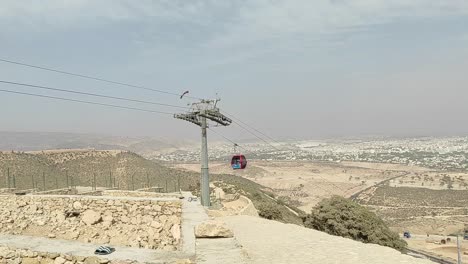 Cable-car-of-the-aerial-tramway-connecting-Oufella-peak-and-Agadir-city-in-Morocco,-overlooking-a-panoramic-view-of-the-beach-9