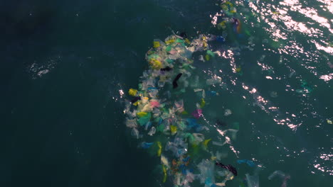Aerial-birdseye-flying-over-garbage-floating-on-sea-waters