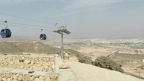 Cable-car-of-the-aerial-tramway-connecting-Oufella-peak-and-Agadir-city-in-Morocco,-overlooking-a-panoramic-view-of-the-beach-22
