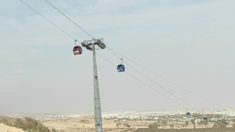 Cable-car-of-the-aerial-tramway-connecting-Oufella-peak-and-Agadir-city-in-Morocco,-overlooking-a-panoramic-view-of-the-beach-20