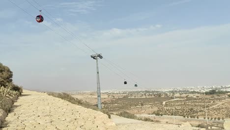 Cable-car-of-the-aerial-tramway-connecting-Oufella-peak-and-Agadir-city-in-Morocco,-overlooking-a-panoramic-view-of-the-beach-19