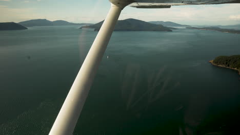 Small-Jet-Plane-Flying-Over-San-Juan-Islands-In-Washington-State,-USA