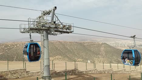 Cable-car-of-the-aerial-tramway-connecting-Oufella-peak-and-Agadir-city-in-Morocco,-overlooking-a-panoramic-view-of-the-beach-14