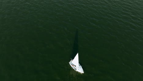 Top-Down-Aerial-View-of-Sailboat-Sailing-on-Water-Reservoir,-Zagrze-Lake,-Poland,-High-Angle-Drone-Shot