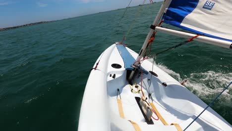 Solo-Sailing-dinghy-boat-in-deep-ocean-water,-POV-view