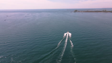 Aerial-View-of-Speedboat-Motorboat-Navigating-Fast-at-High-Speed-on-Turquoise-Water-of-Lake-Erie,-Coast-Area-of-Nickel-Beach-Ontario-Canada-in-Summer,-Nautical-and-Seascape