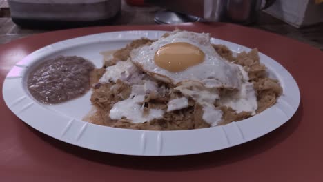 Green-chilaquiles-on-a-plate-with-scrambled-eggs