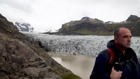 Iceland-glacier-with-man-standing-and-gimbal-video-walking-forward-in-slow-motion