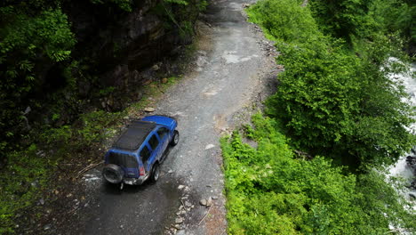Nissan-Xterra-Vehicle-Driving-On-The-Abano-Pass-Dirt-Road-Passing-By-In-The-Valley-In-Georgia