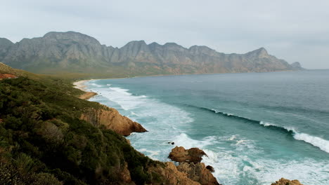 Scenic-Kogel-Bay-on-Clarence-Drive,-surrounded-by-Hottentots-Holland-mountains