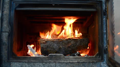 Closing-the-door-on-a-woodburning-stove-fireplace-on-a-cold-winter-day