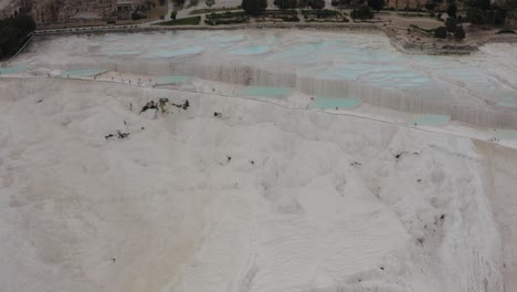 Drone-flying-away-from-Pammukale-White-Termal-Pool-Natural-Hot-Spring-terrace-Turkey