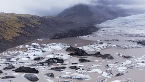 Glacial-lagoon-filled-with-icebergs-at-Kvíarjökull-glacier,-melting-by-global-warming