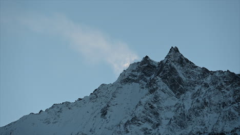 A-Swiss-rocky-snowy-Mountain-in-the-Swiss-alps-during-winter,-Saas-Fee,-blue-sky