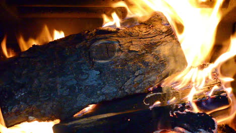 A-closeup-shot-of-a-burning-log-in-a-woodburning-stove-fireplace