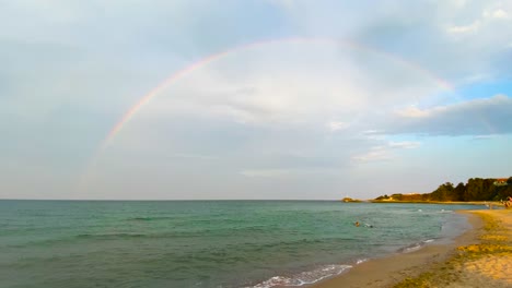 Complete-full-rainbow-over-the-sea.-Hand-shot