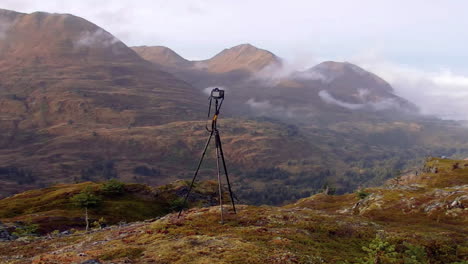 A-panning-shot-of-a-camera-and-tripod-set-up-in-preparation-for-a-photoshoot-in-the-mountain-wilderness-of-Kodiak-Island-Alaska