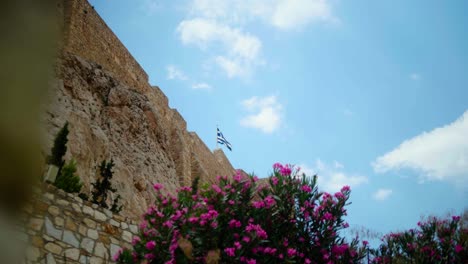 Greek-flag-waving-in-the-wind-on-top-of-an-ancient-fort-in-Athens