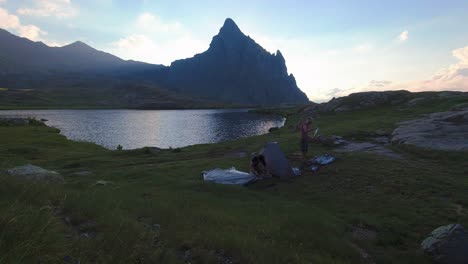 Timelapse-of-two-hikers-Setting-tent-in-Anayet-mountain-range-peak-and-lake-in-Spanish-Pyrenees